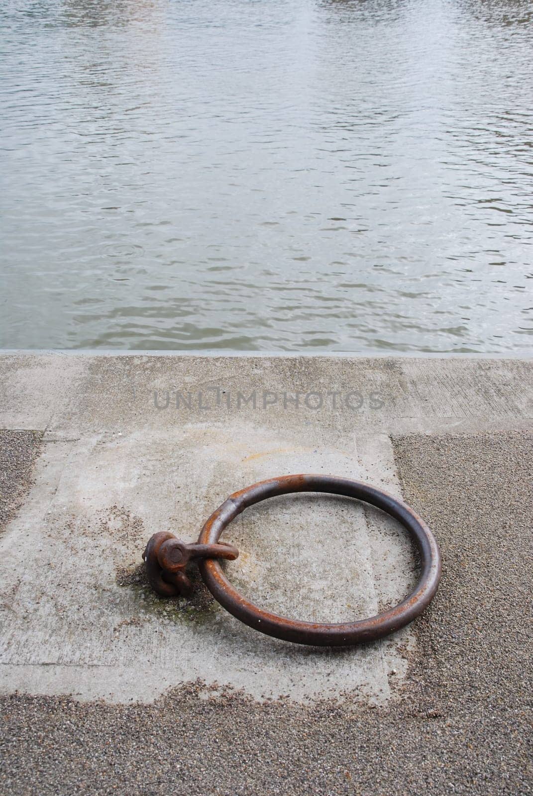 old and rusty mooring ring for ships on dock