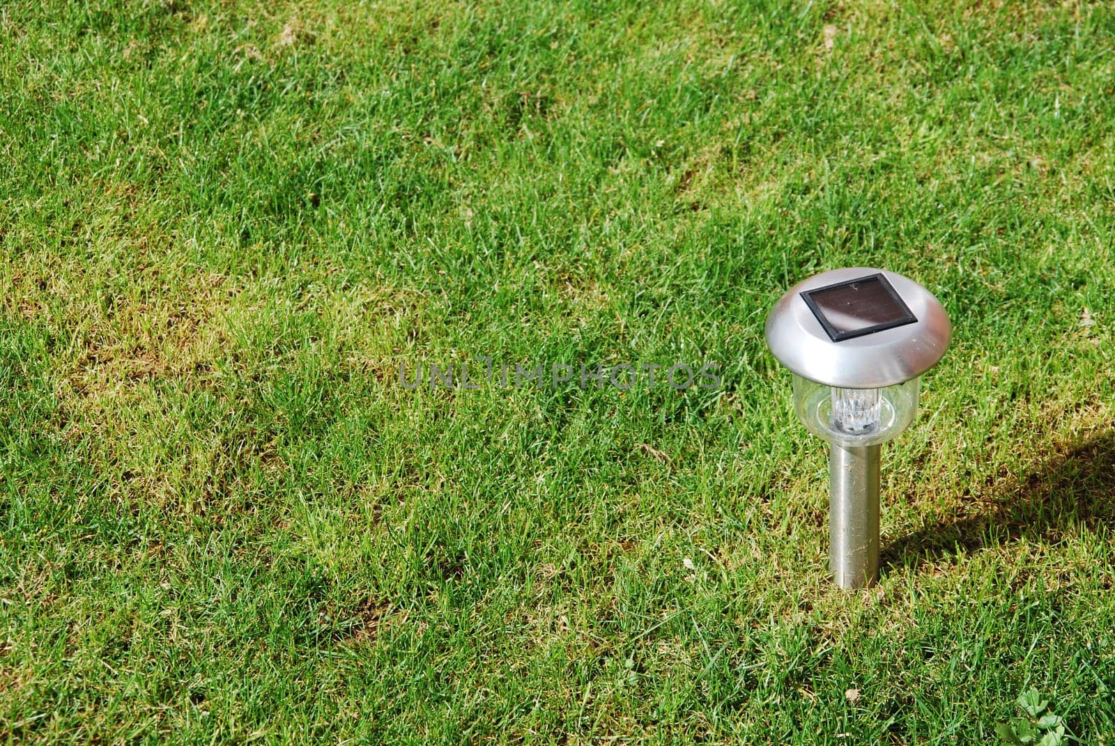 close-up of a solar garden light on green grass
