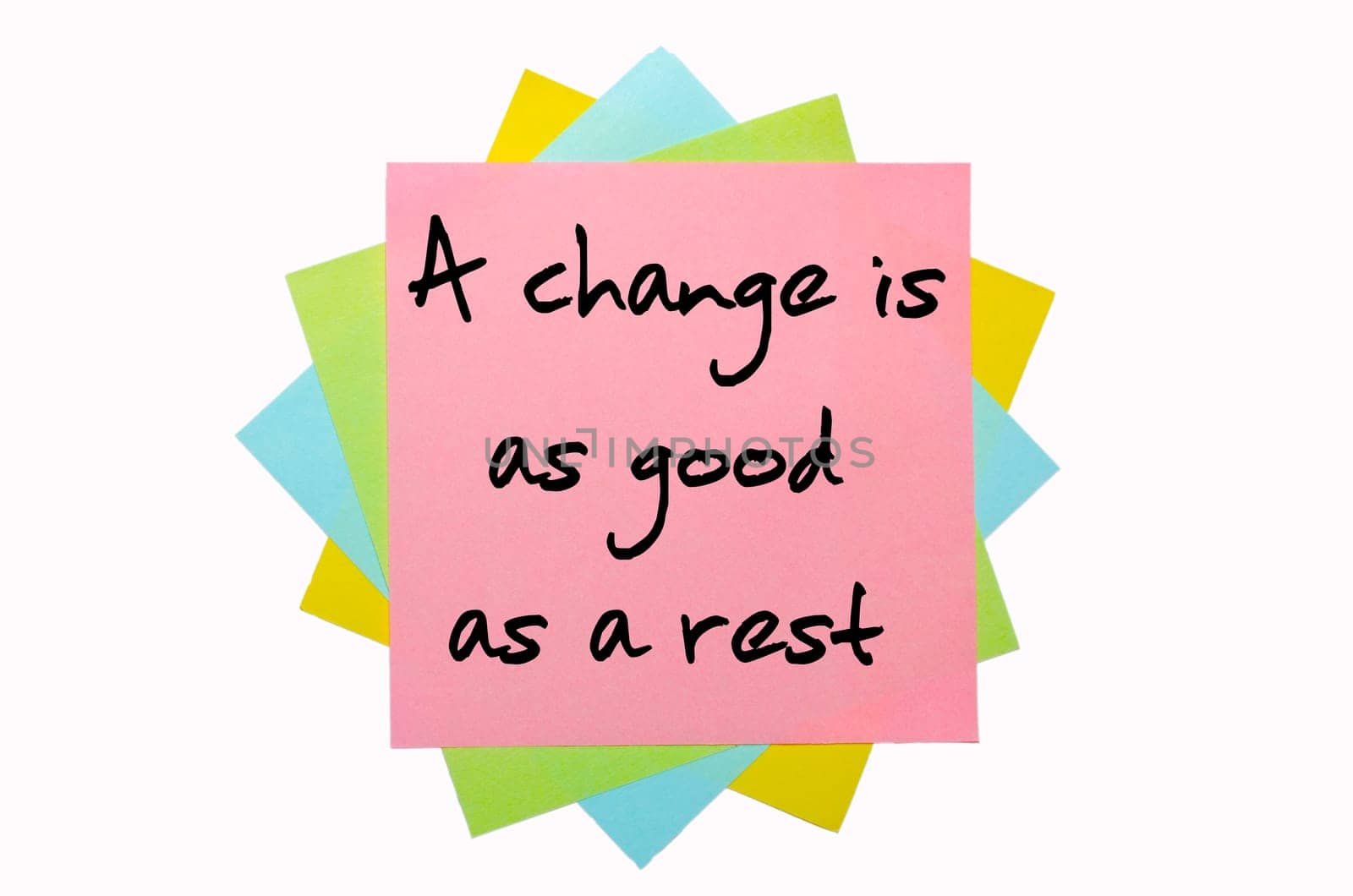 text "A change is as good as a rest"" written by hand font on bunch of colored sticky notes"
