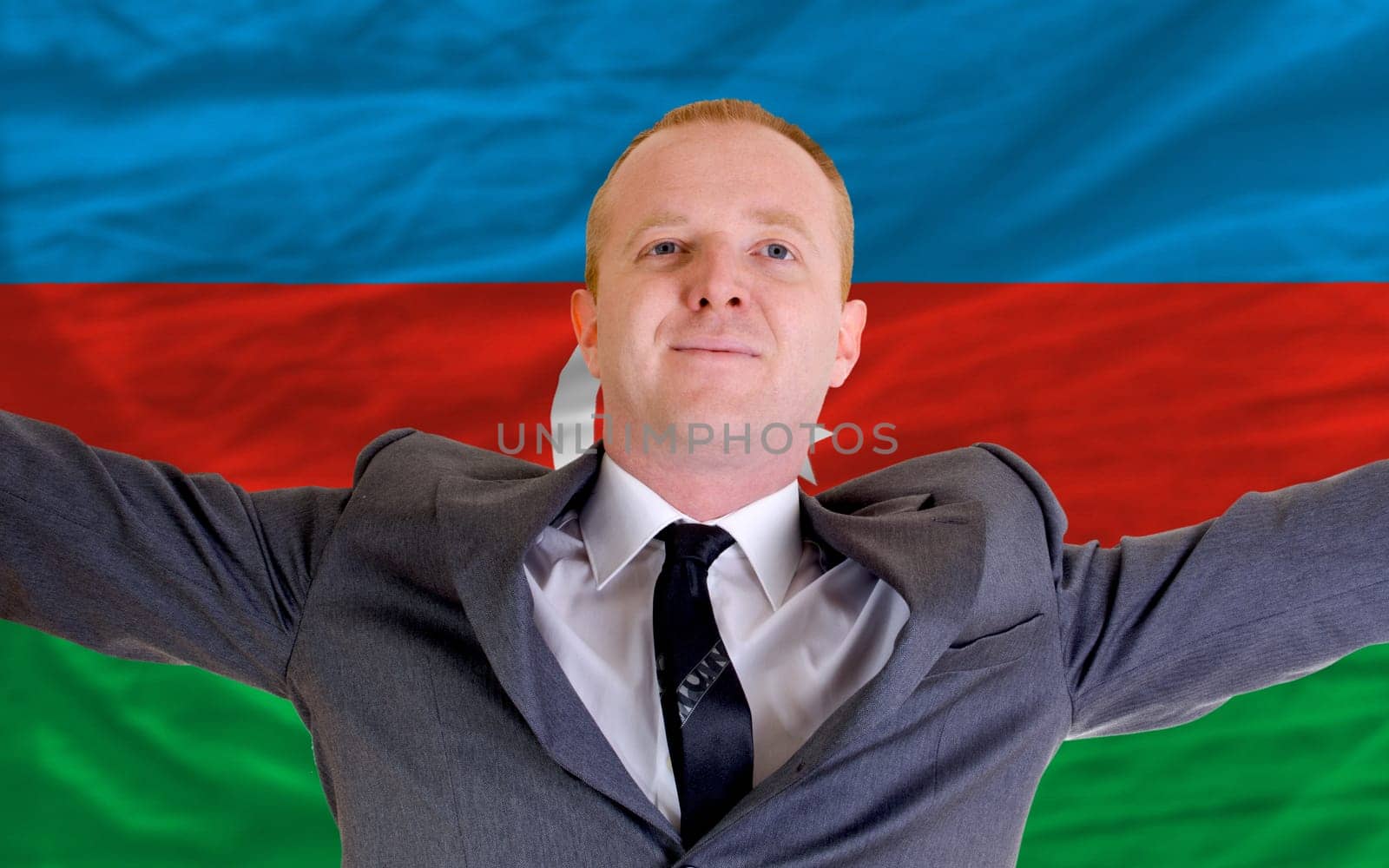 joyful investor spreading arms after good business investment in azerbaijan, infront of flag
