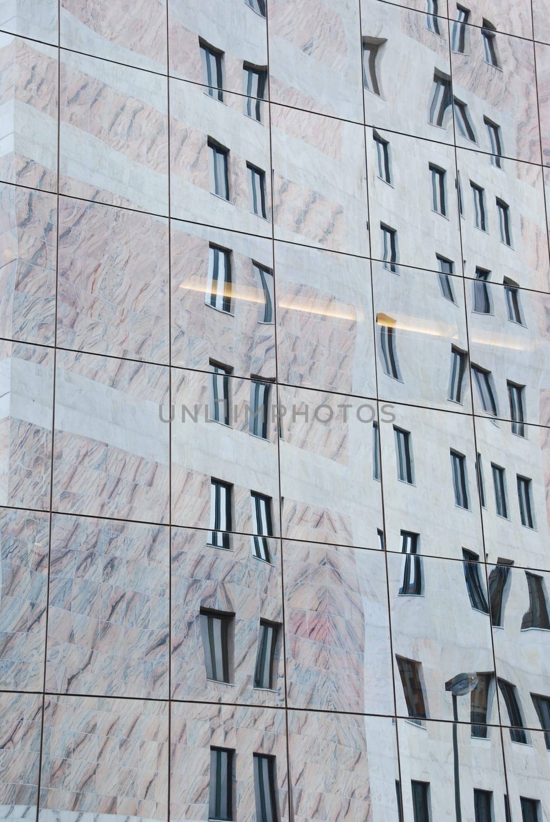 reflection of a residential building on a office building facade