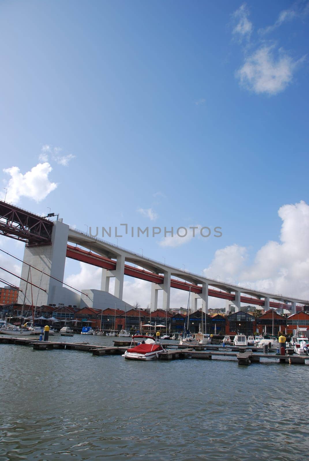 beautiful docks in Lisbon, on the background the typical houses used as restaurants/pubs (under April 25th bridge)