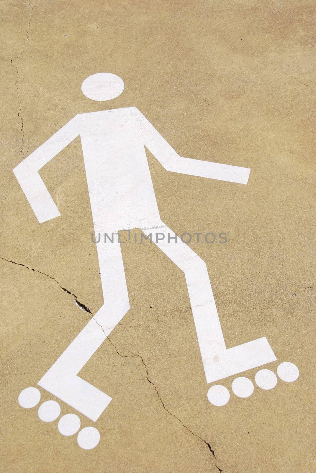 white rollerblading sign on a urban park (yellow cement surface)