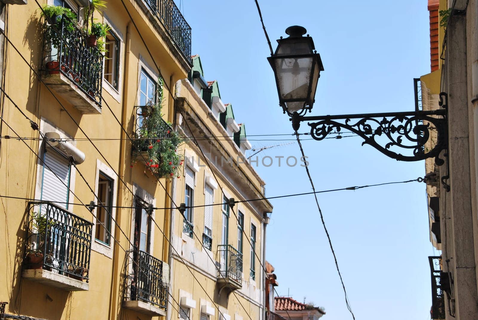 beautiful and traditional view of antique building and lamp in Lisbon, Portugal (river tagus background)