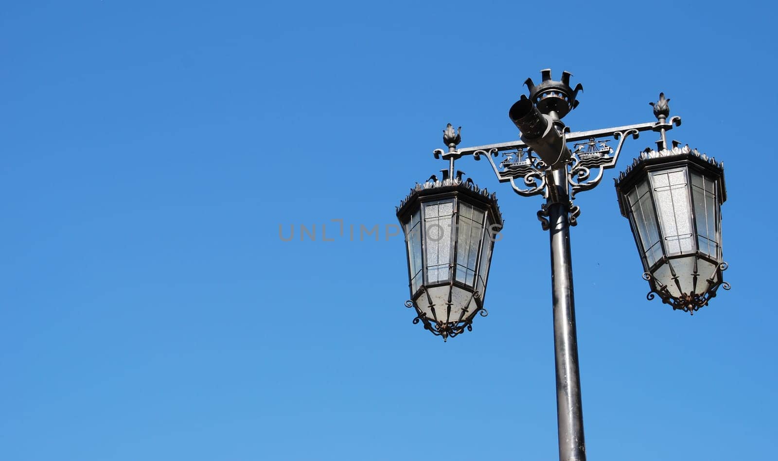 vintage lamp posts against blue sky background