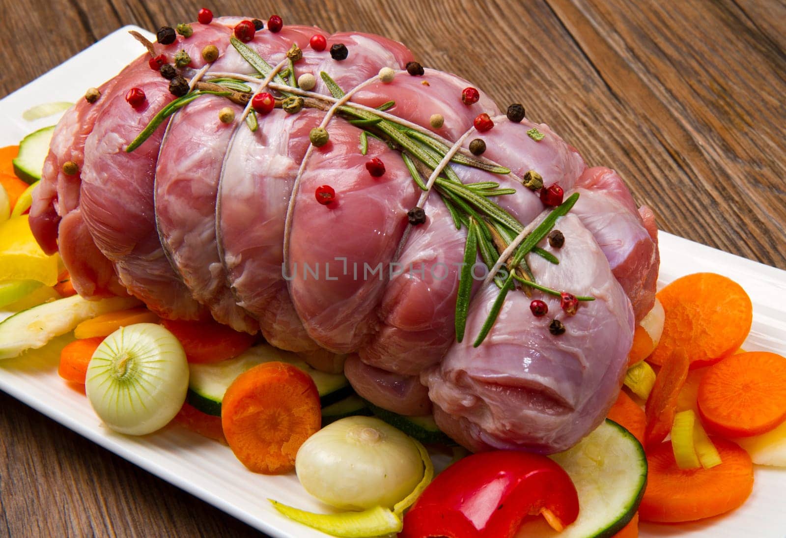 roast of beef with fresh vegetables ready to cook