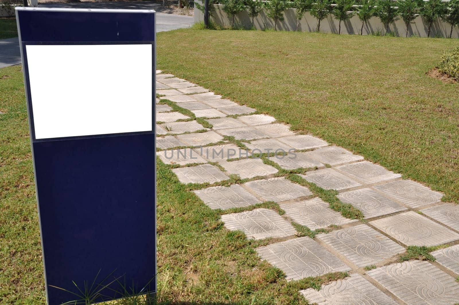 blank billboard and stone walkway in the park