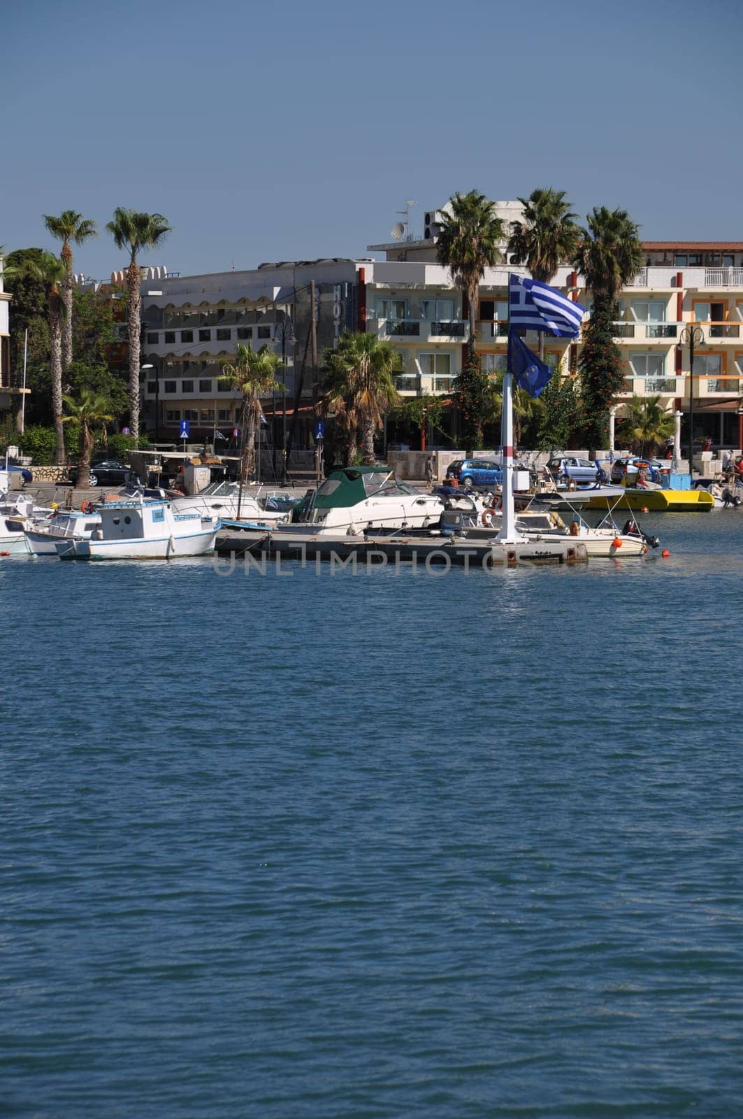 Greece and EU flags at Kos harbour (seascape view)