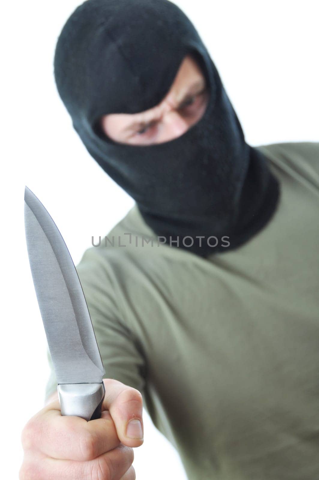 Bandit in black balaclava with knife in hand isolated on white background