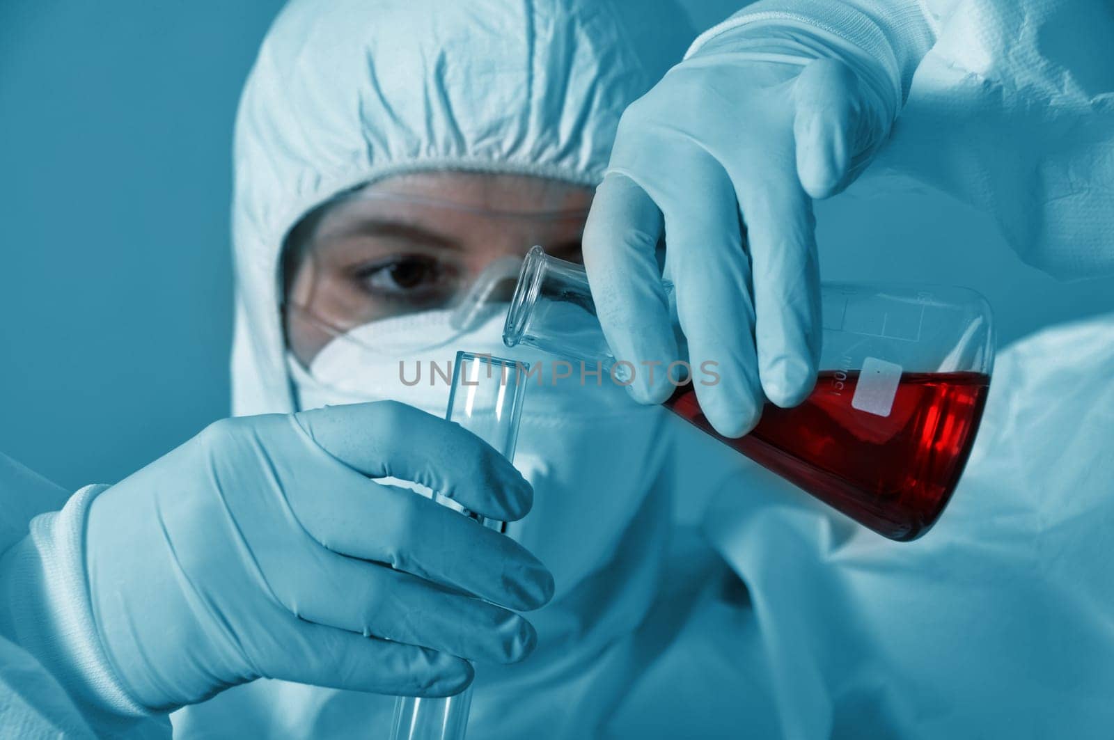Scientist pouring chemicals in a laboratory
