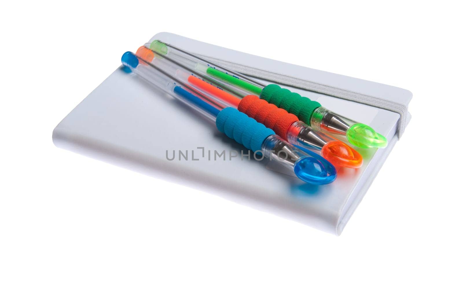 grey notebook diary or agenda and colored pens lying on the top (isolated on white background)