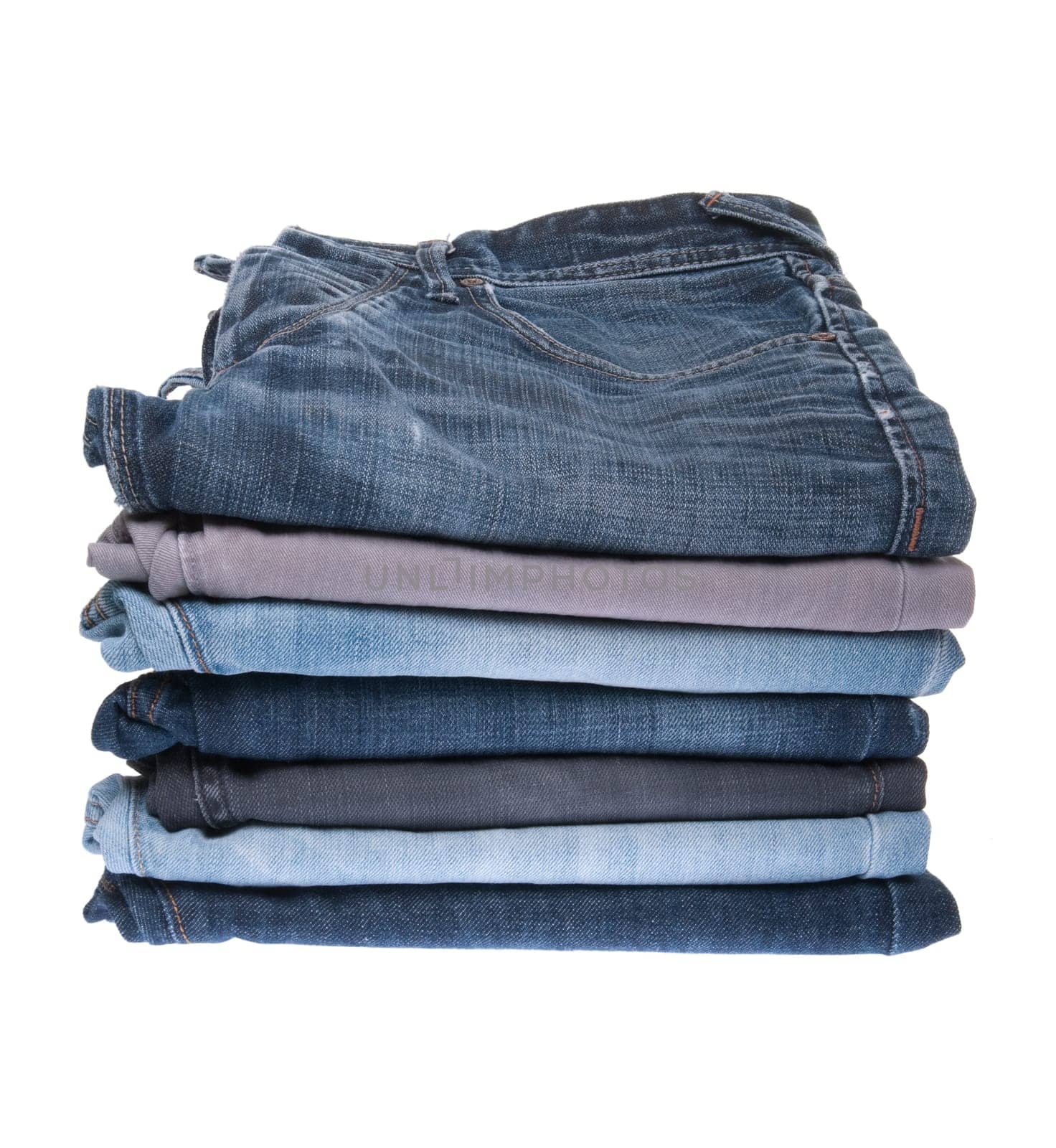 stack of various jeans isolated on white background