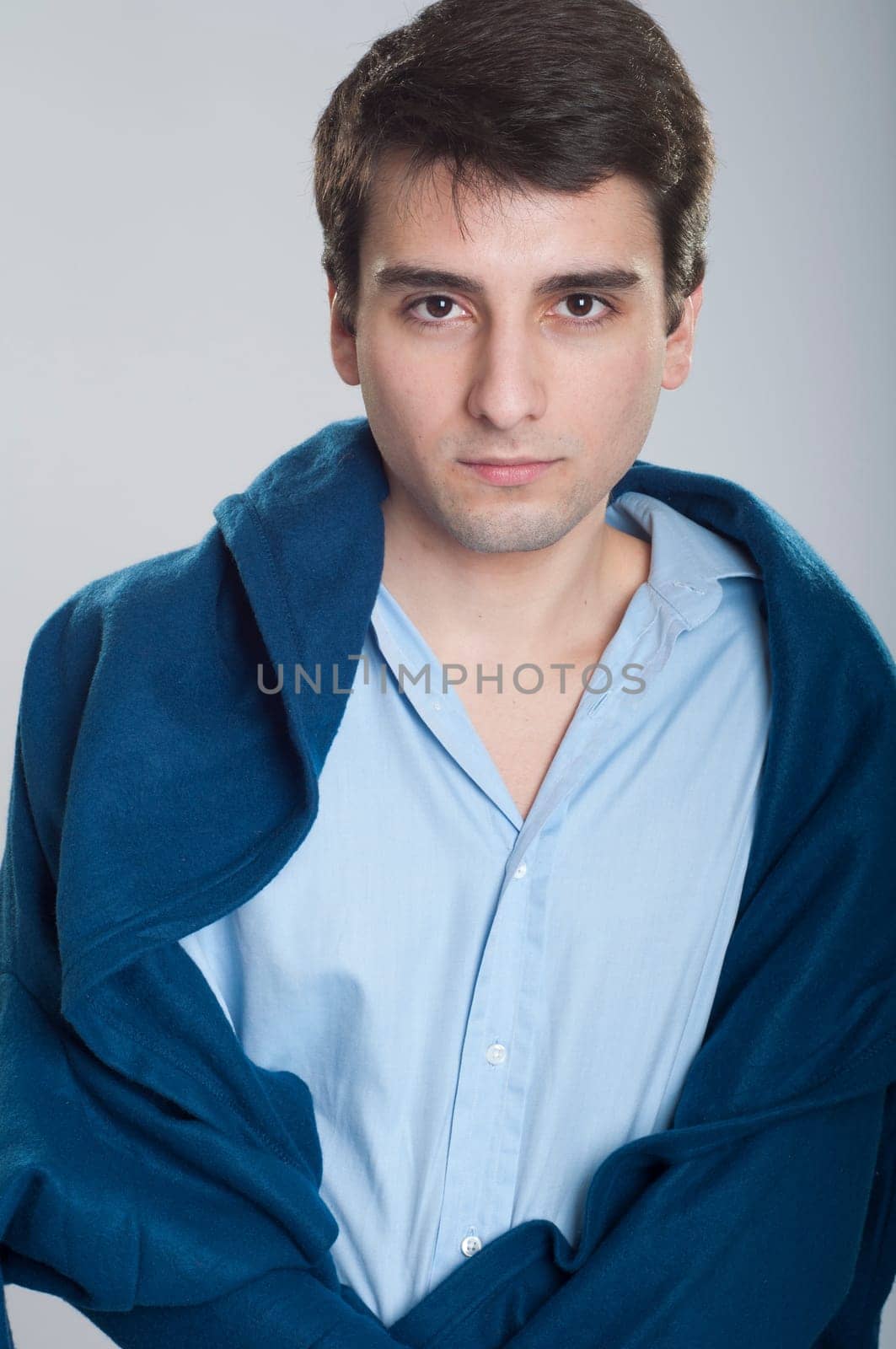portrait of a sick young business man with blanket