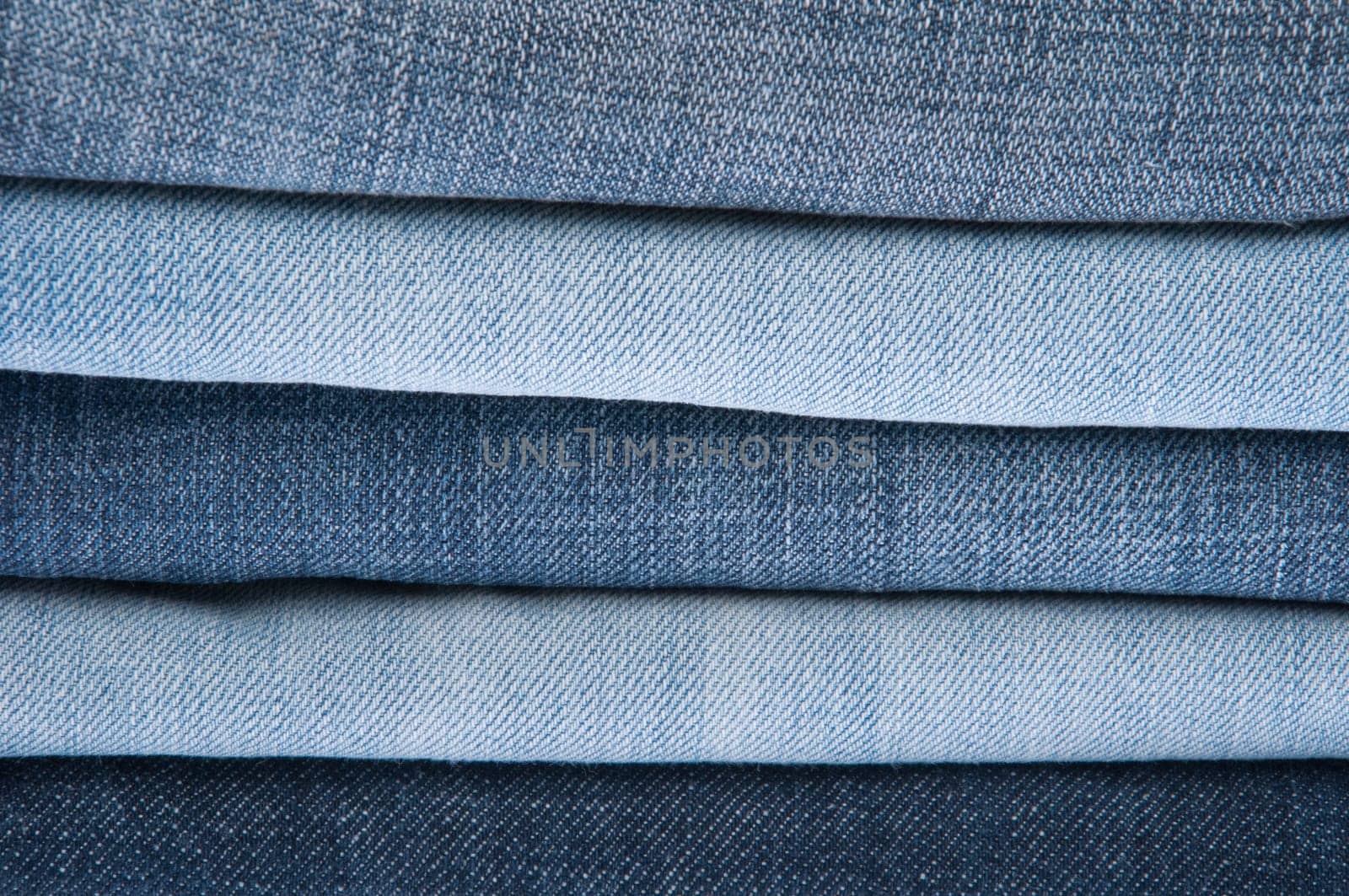 stack of blue jeans as a background or texture
