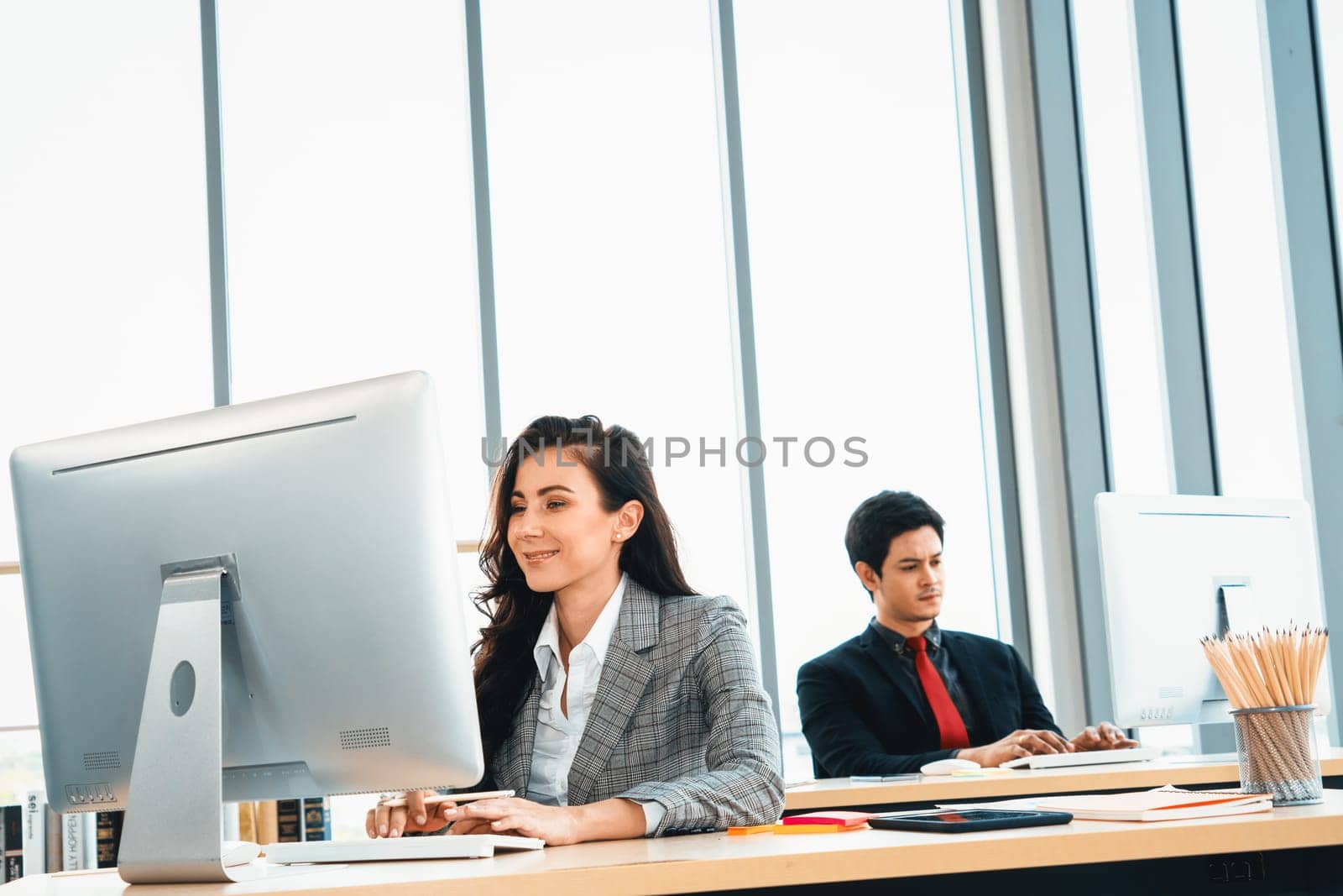Business people working at table in modern office Jivy by biancoblue