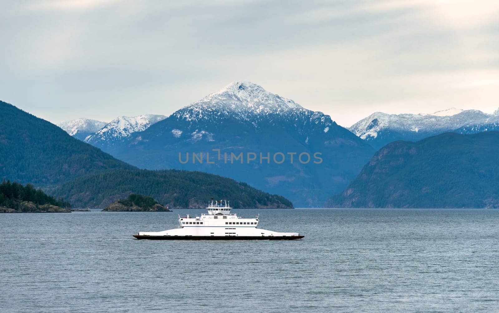 Smaller ferry vessel going by Pacific ocean bay by Imagenet