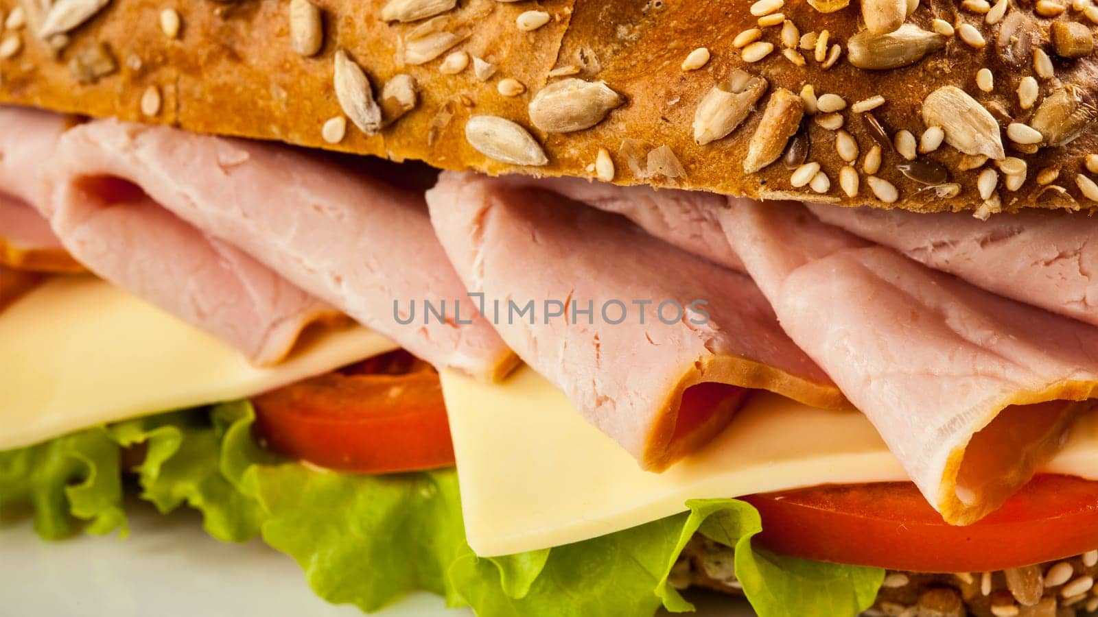 Panorama of ham sandwich with lettuce, cheese, tomato close up
