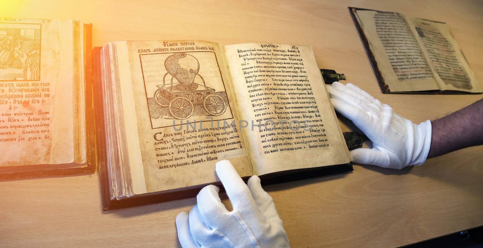 An old book in a scientist's hands, close-up. Christian antique book in the hands of a librarian.