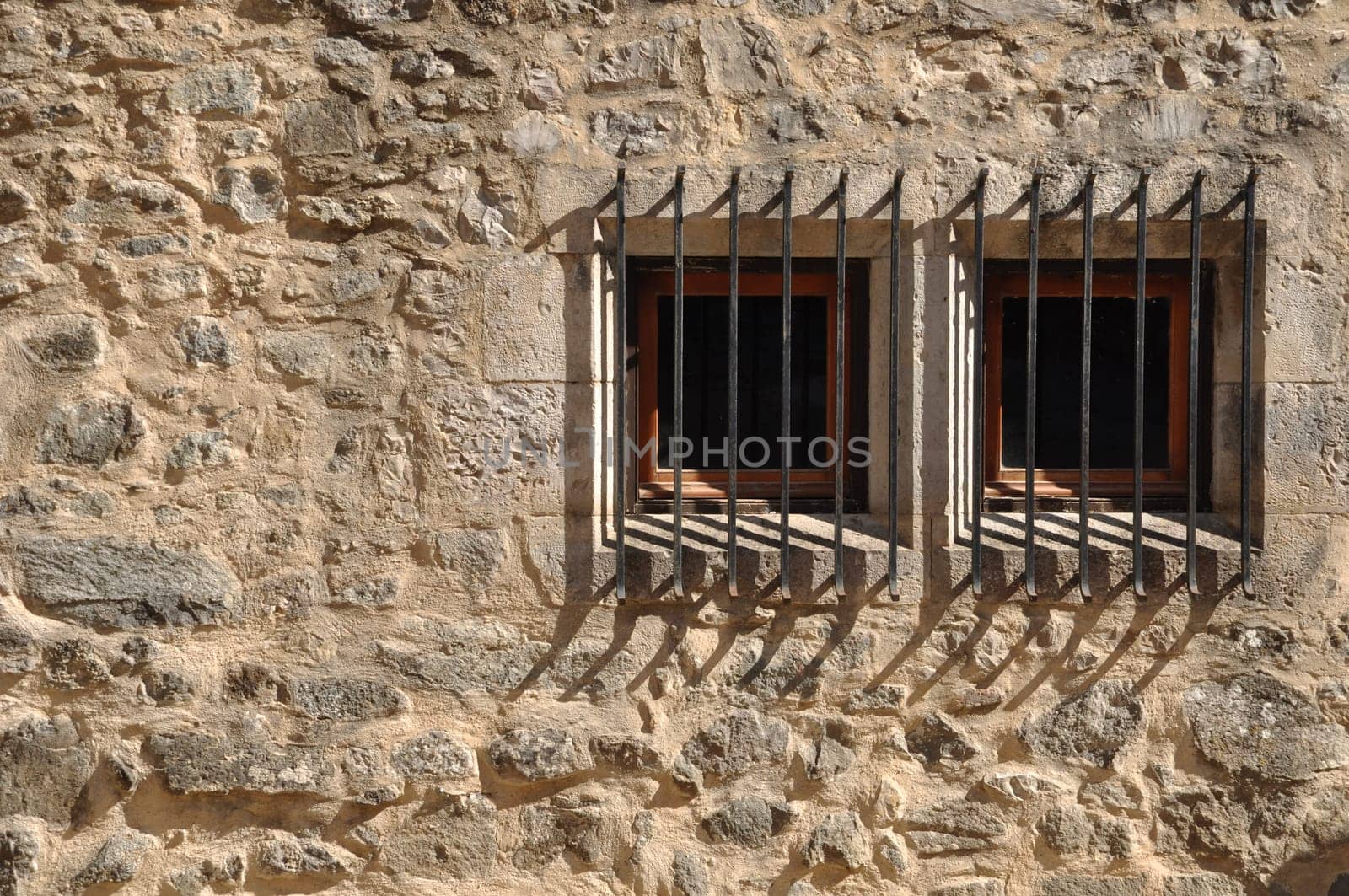 ancient windows of a medieval building with bars