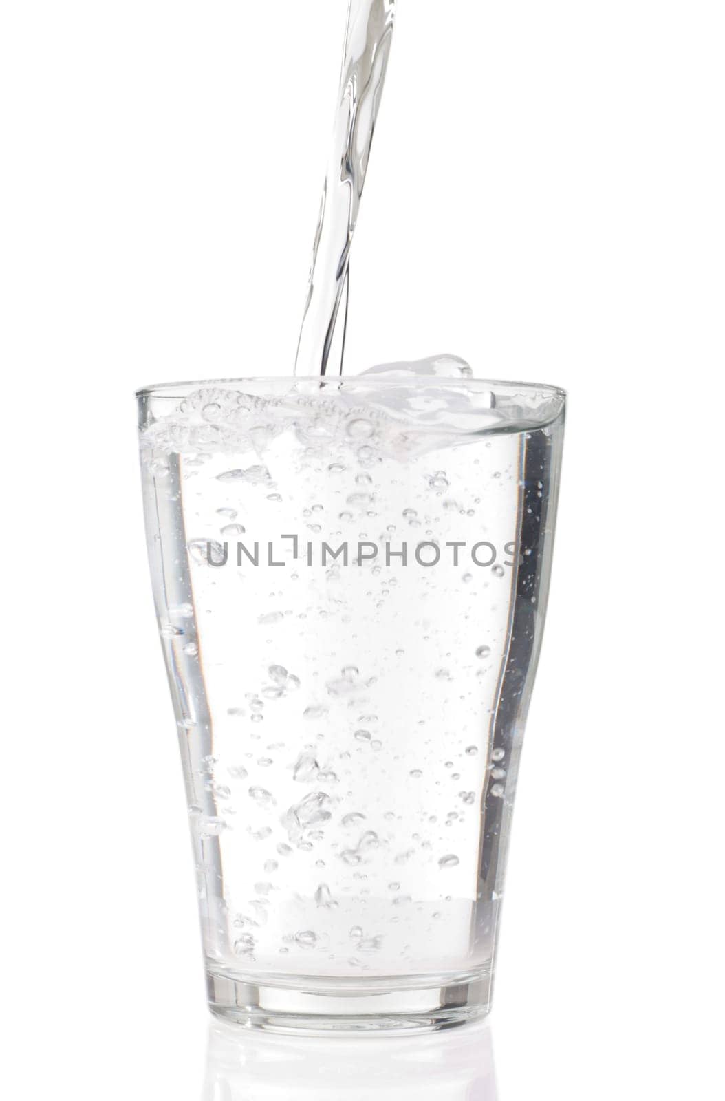 fresh water pouring into a glass isolated on white background