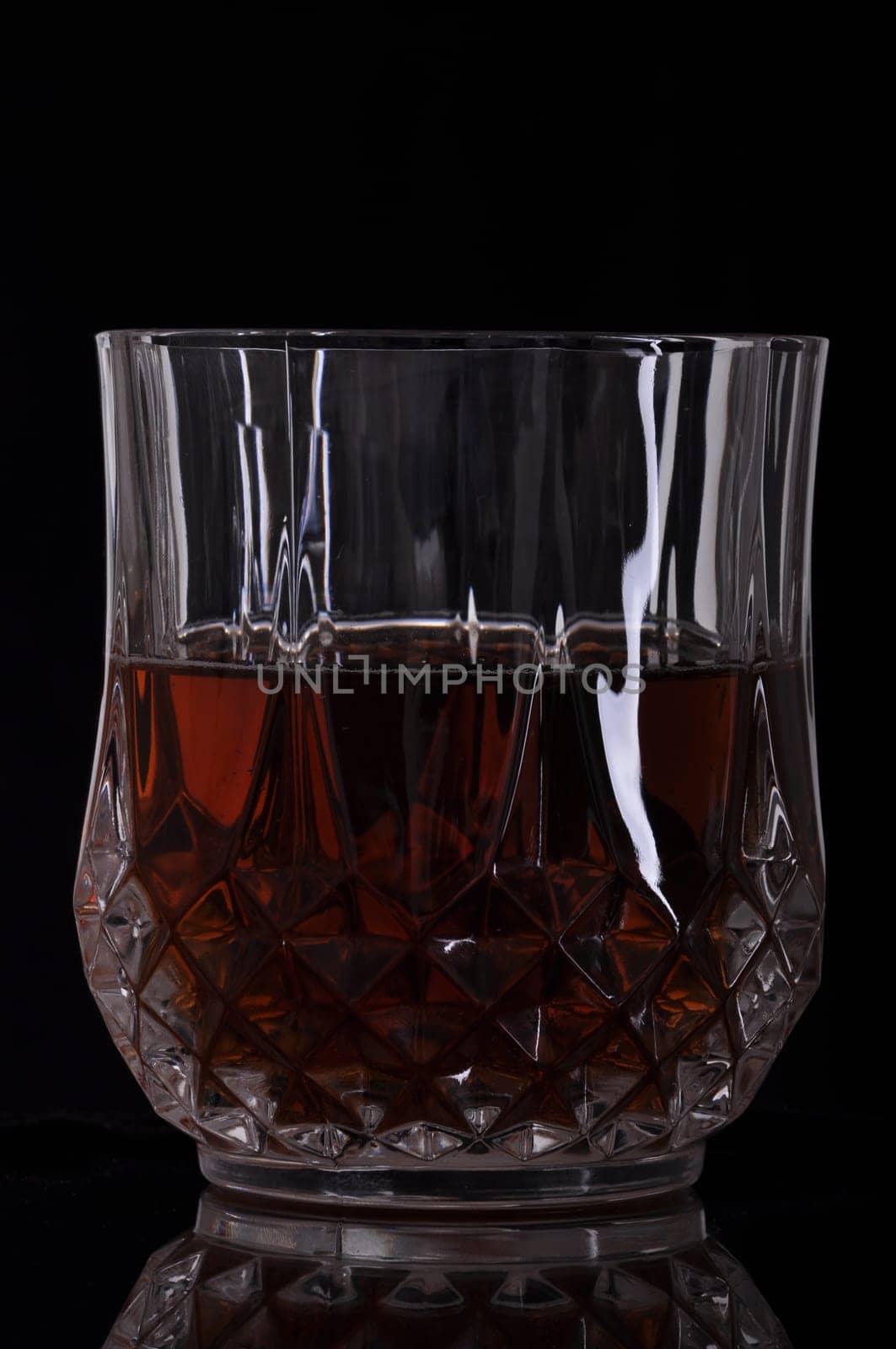 gorgeous glass of whisky on black background