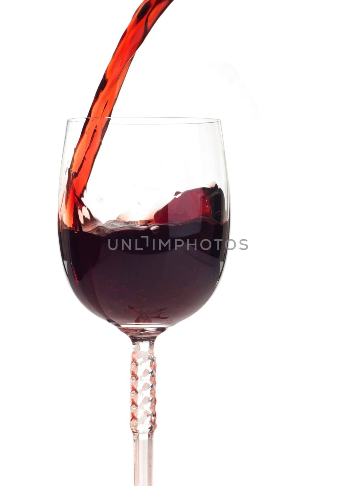 red wine pouring into a crystal glass (isolated on white background)