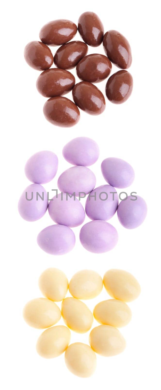 collection of chocolate coated almonds (brown, purple, white) isolated on white background