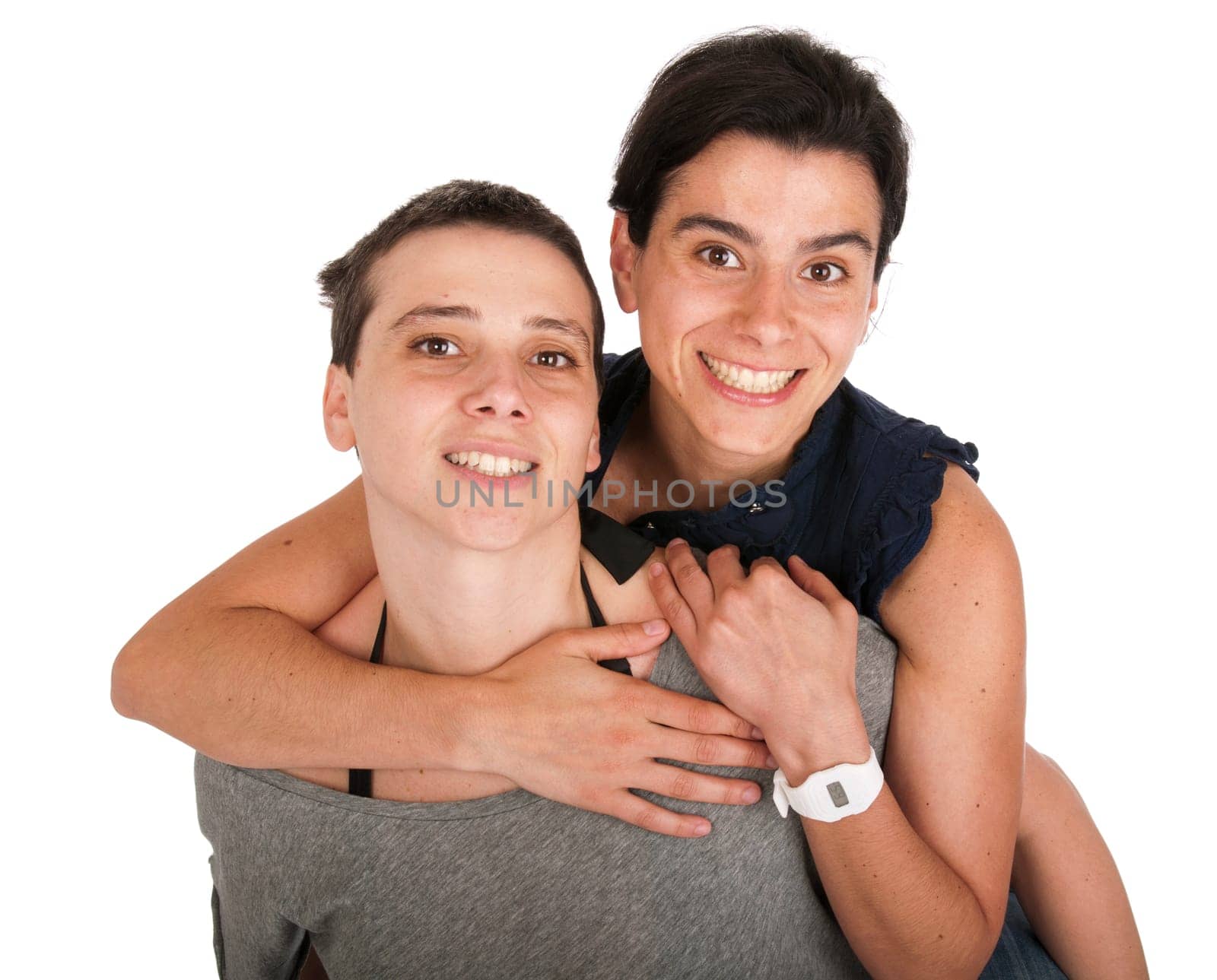 happy smiling sisters portrait, younger sister giving a lovely hug to older sis while playing piggyback together (isolated on white background)