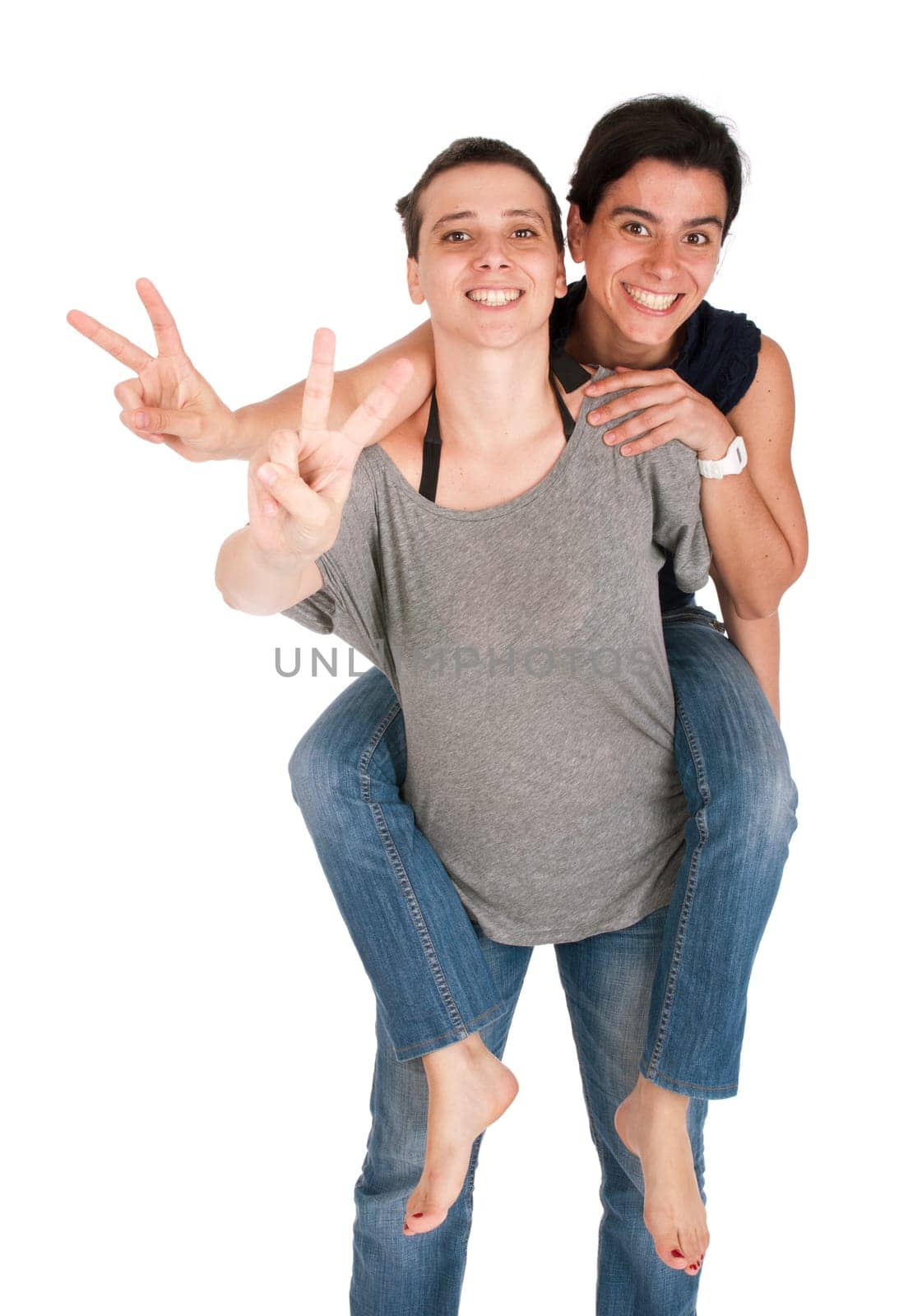 happy smiling sisters showing victory hand sign while playing together piggyback, isolated on white background