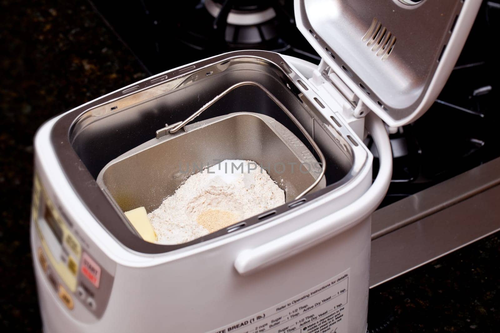 Bread making machine with ingredients prepared for mixing