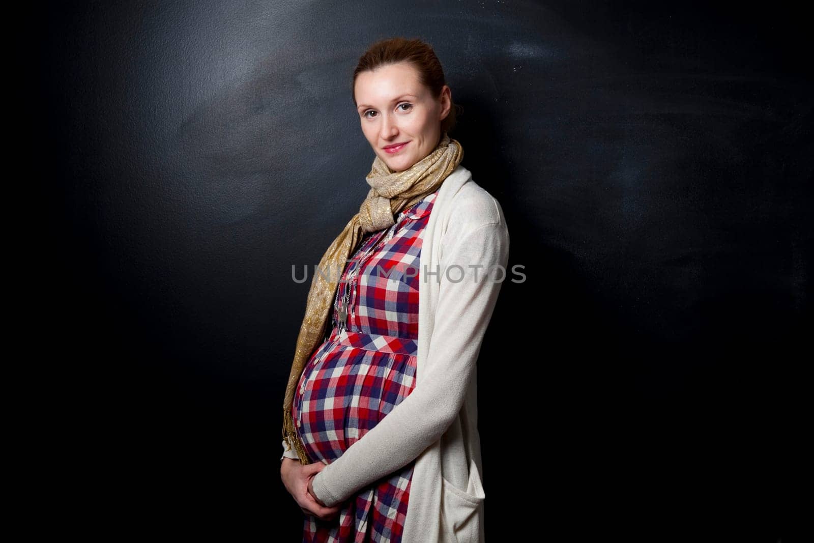 Portrait of a beautiful pregnant mother. Studio shot.