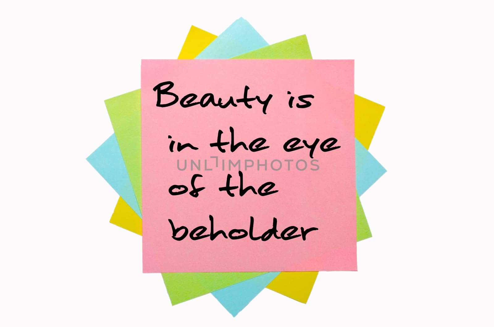 text "Beauty is in the eye of the beholder"" written by hand font on bunch of colored sticky notes"