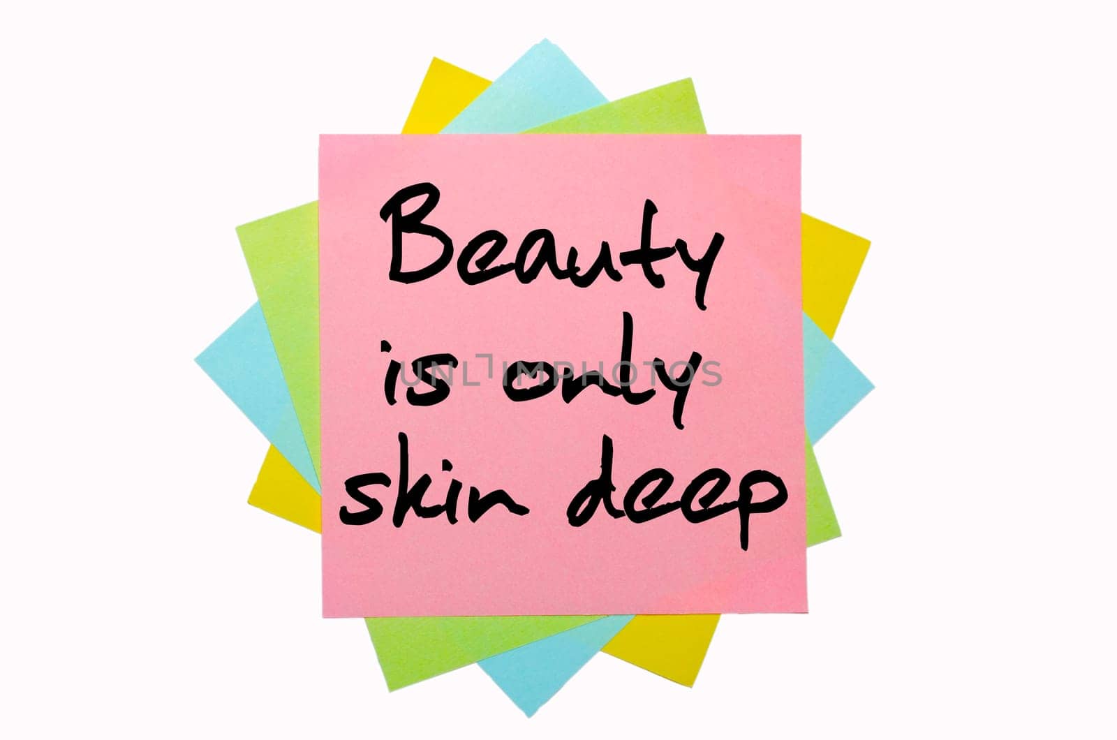 text "Beauty is only skin deep"" written by hand font on bunch of colored sticky notes"