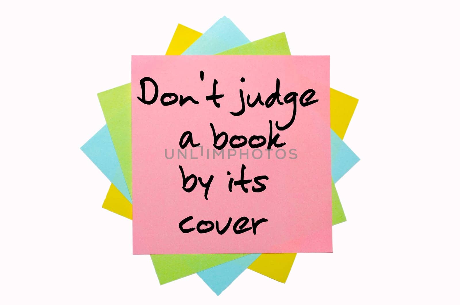 text "Don&#039 t judge a book by its cover"" written by hand font on bunch of colored sticky notes"