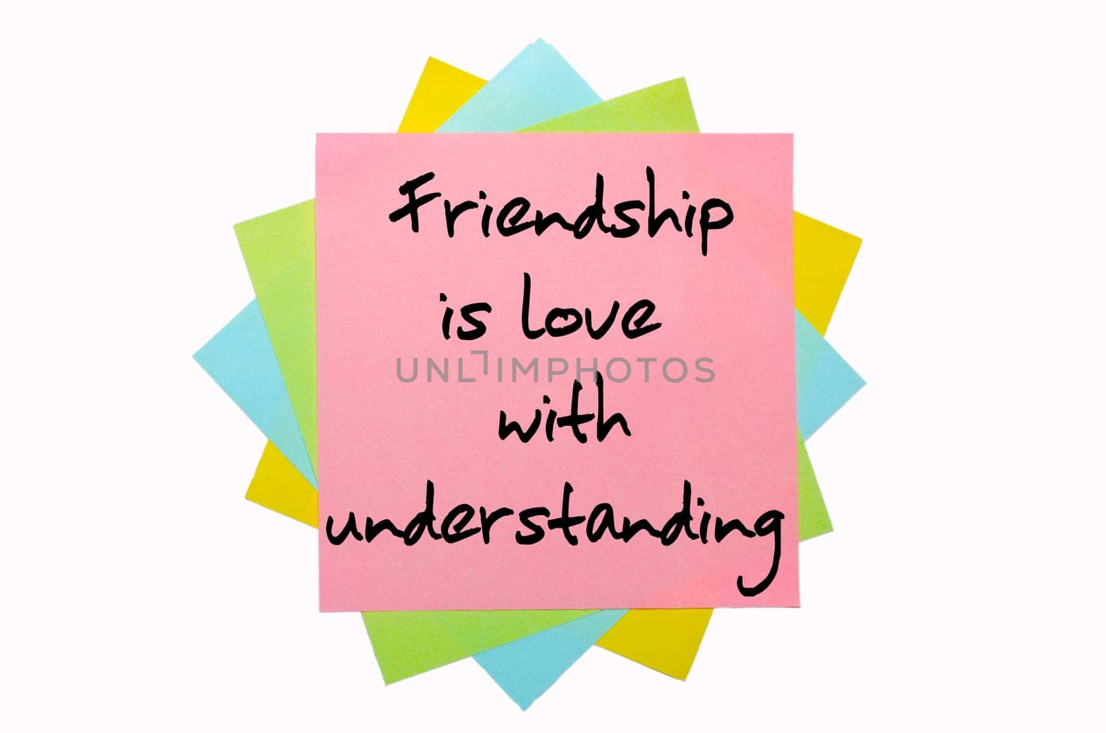 text "  Friendship is love with understanding "" written by hand font on bunch of colored sticky notes"