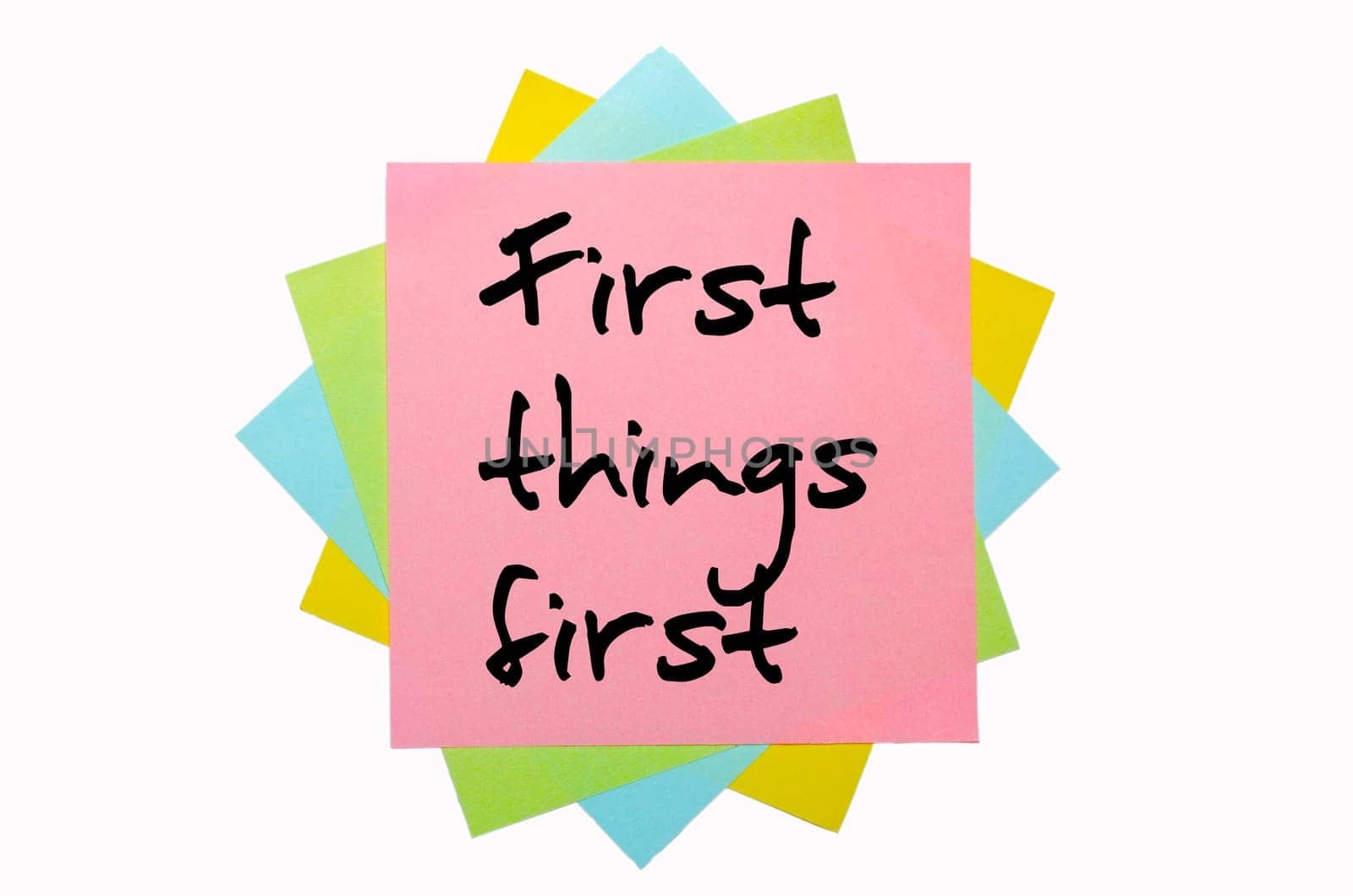 text "  First things first "" written by hand font on bunch of colored sticky notes"