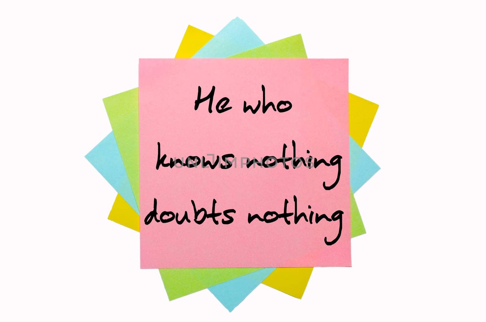 text "  He who knows nothing, doubts nothing "" written by hand font on bunch of colored sticky notes"
