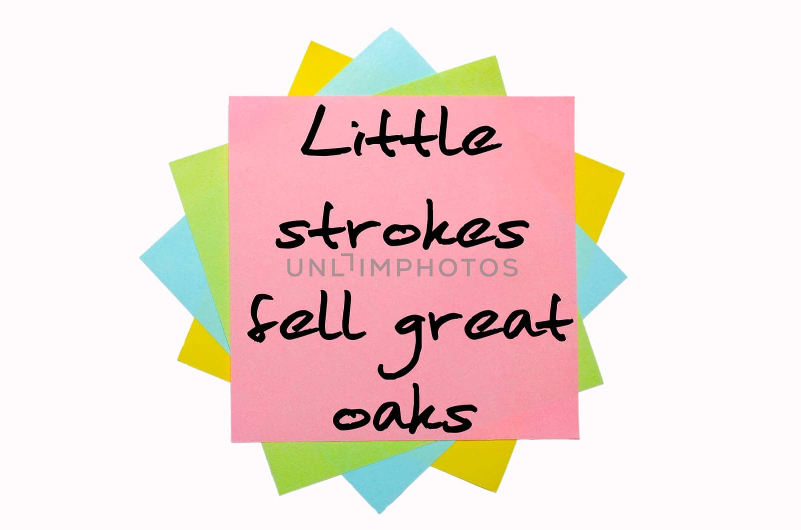 text "Little strokes fell great oaks"" written by hand font on bunch of colored sticky notes"