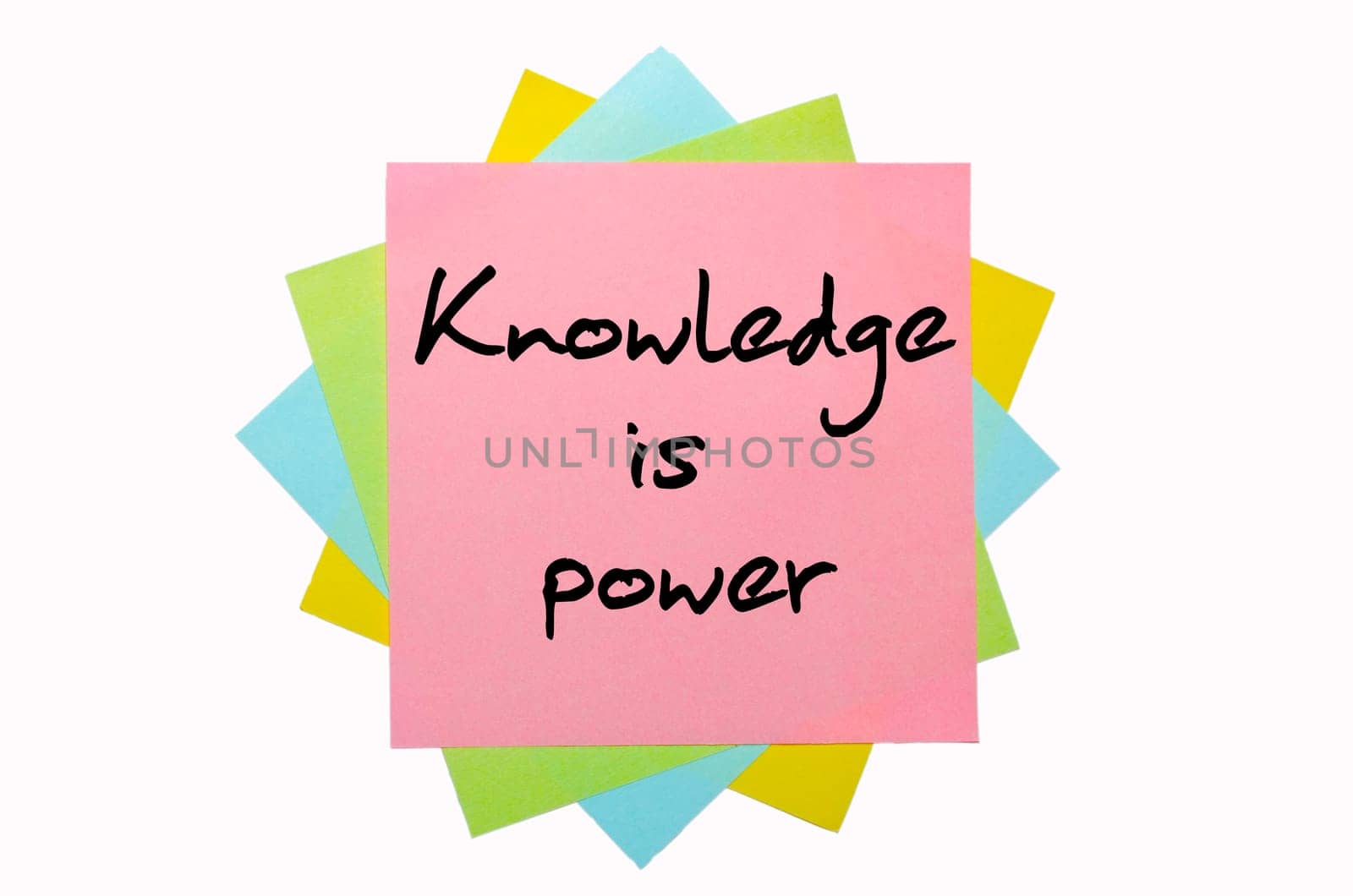text " Knowledge is power "" written by hand font on bunch of colored sticky notes"