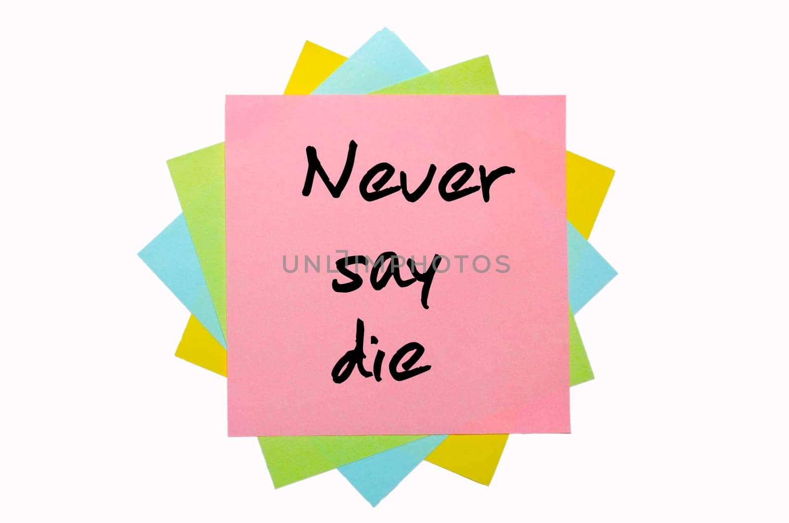text " Never say die "" written by hand font on bunch of colored sticky notes"