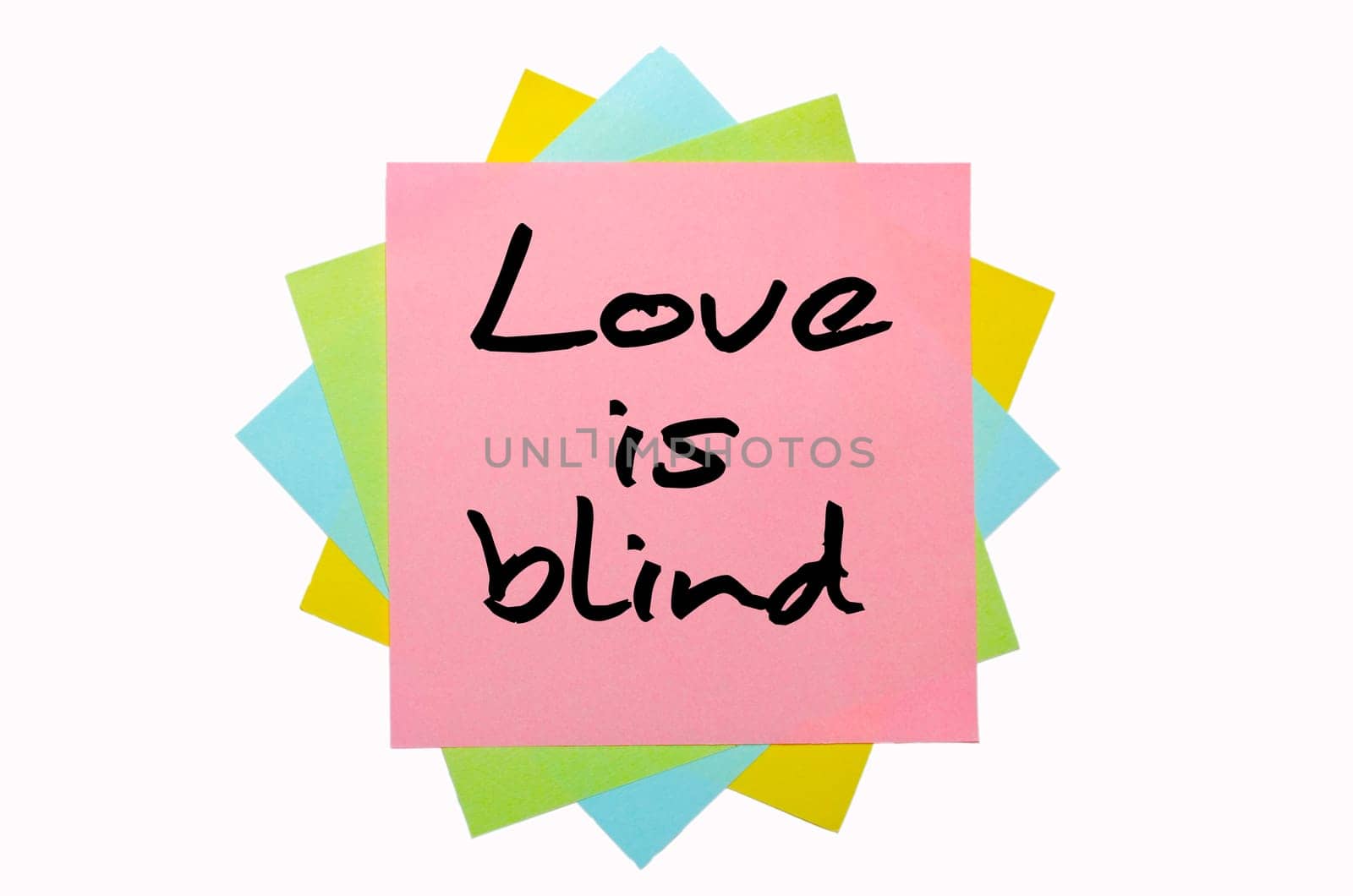text "Love is blind"" written by hand font on bunch of colored sticky notes"