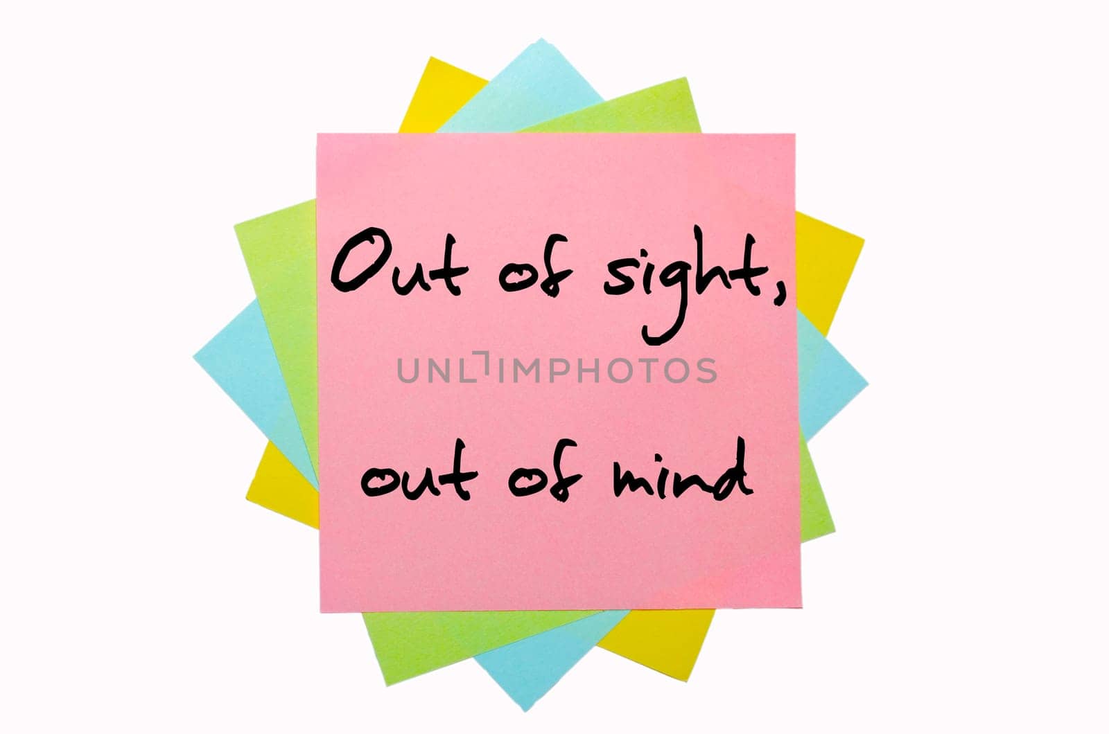 text " Out of sight, out of mind "" written by hand font on bunch of colored sticky notes"