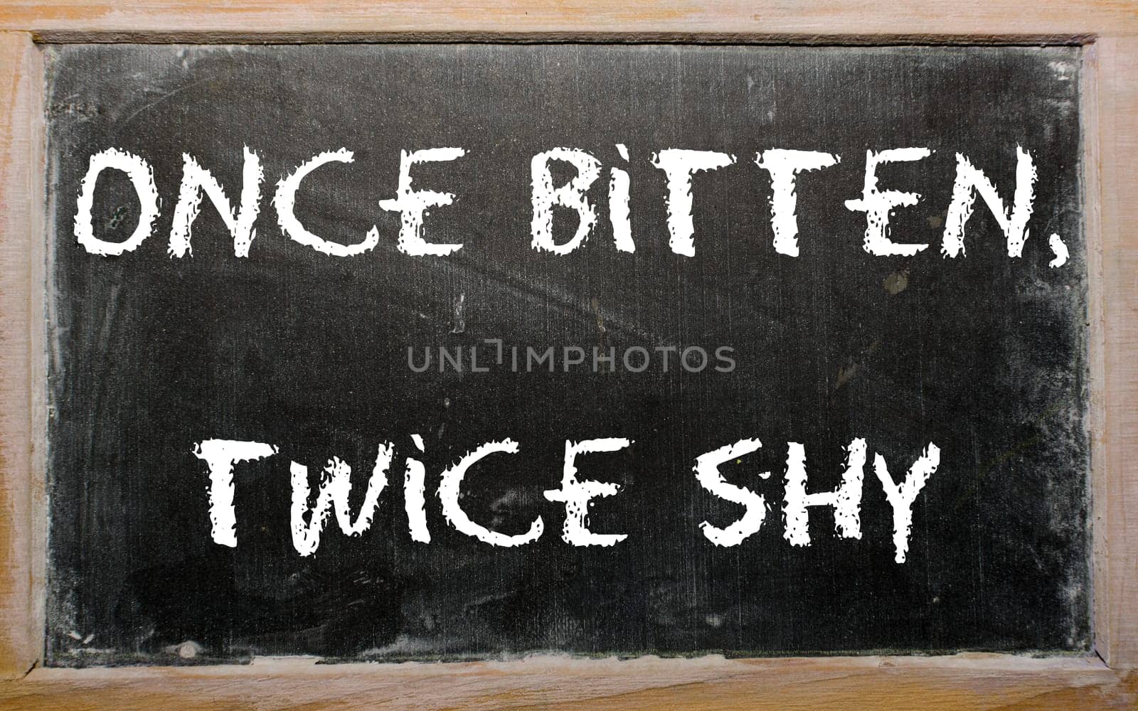 Blackboard writings "Once bitten, twice shy"""