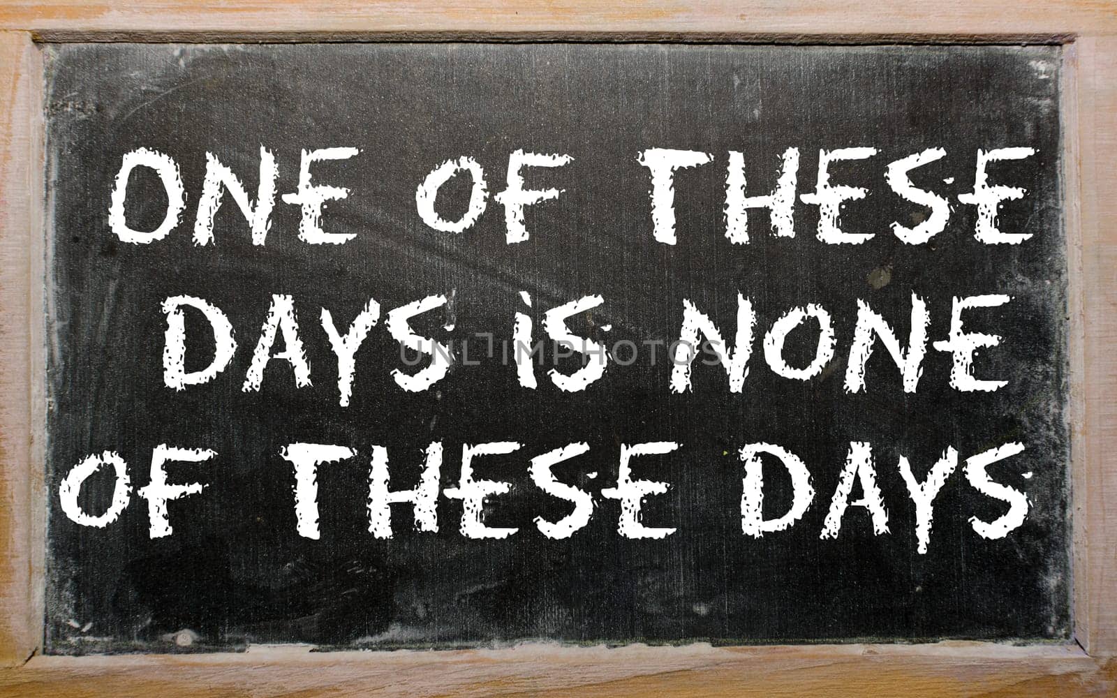 Blackboard writings "One of these days is none of these days"""