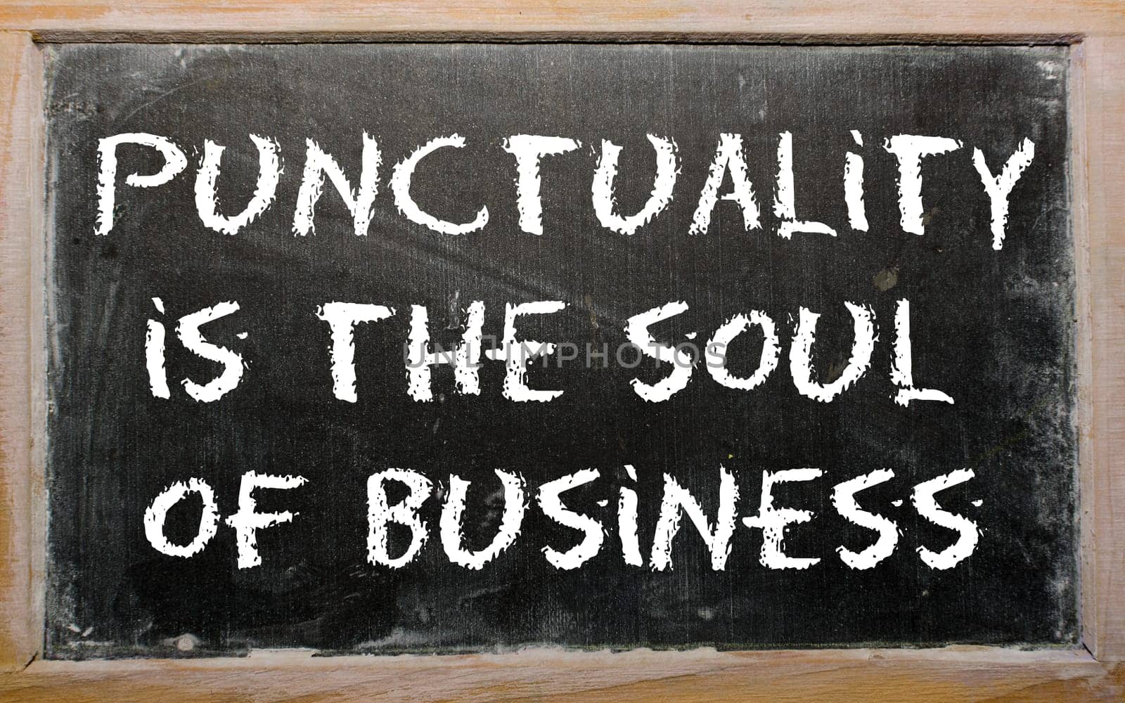 Blackboard writings "Punctuality is the soul of business"""