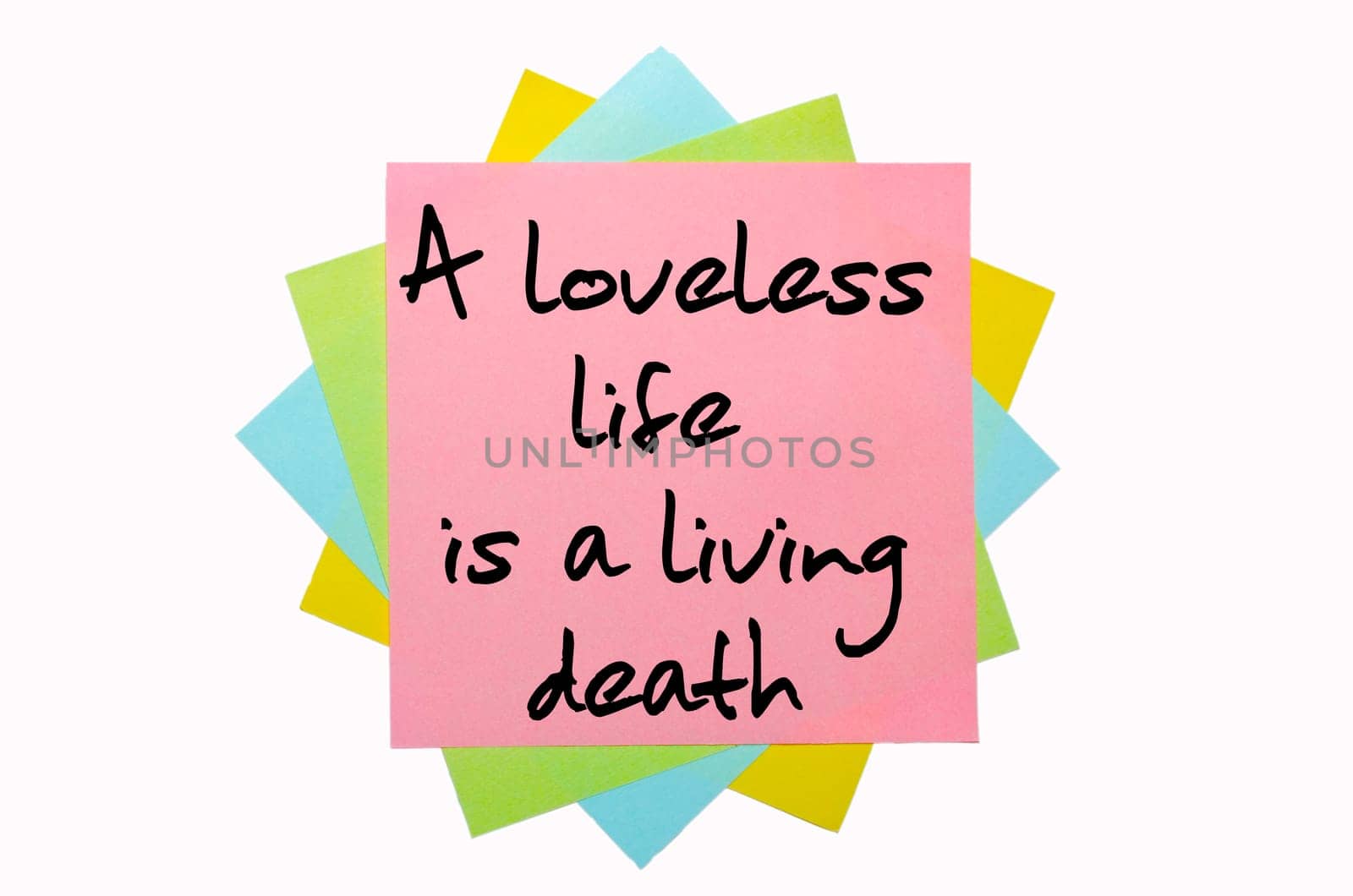 text "A loveless life is a living death"" written by hand font on bunch of colored sticky notes"
