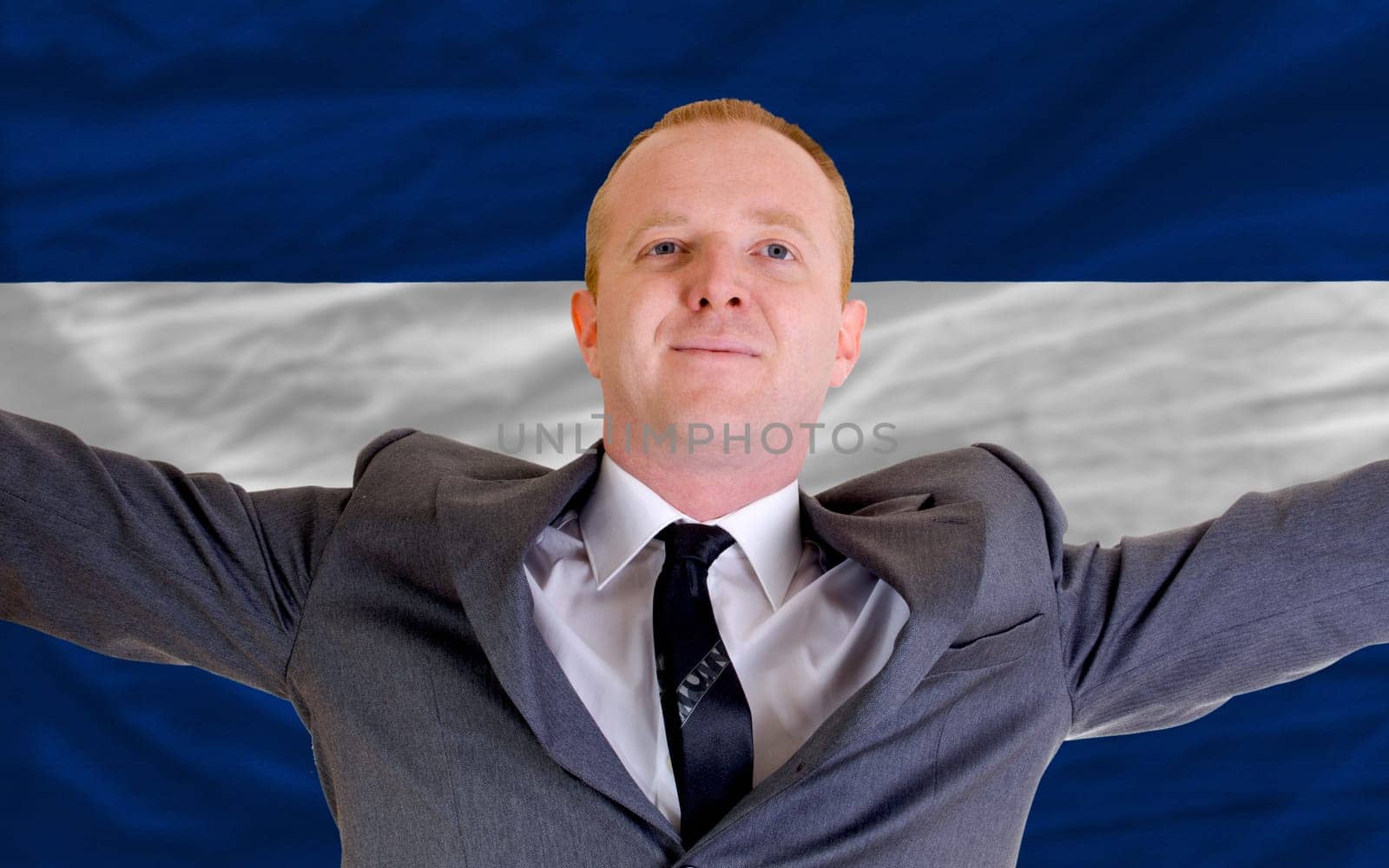 joyful investor spreading arms after good business investment in nicaragua, in front of flag