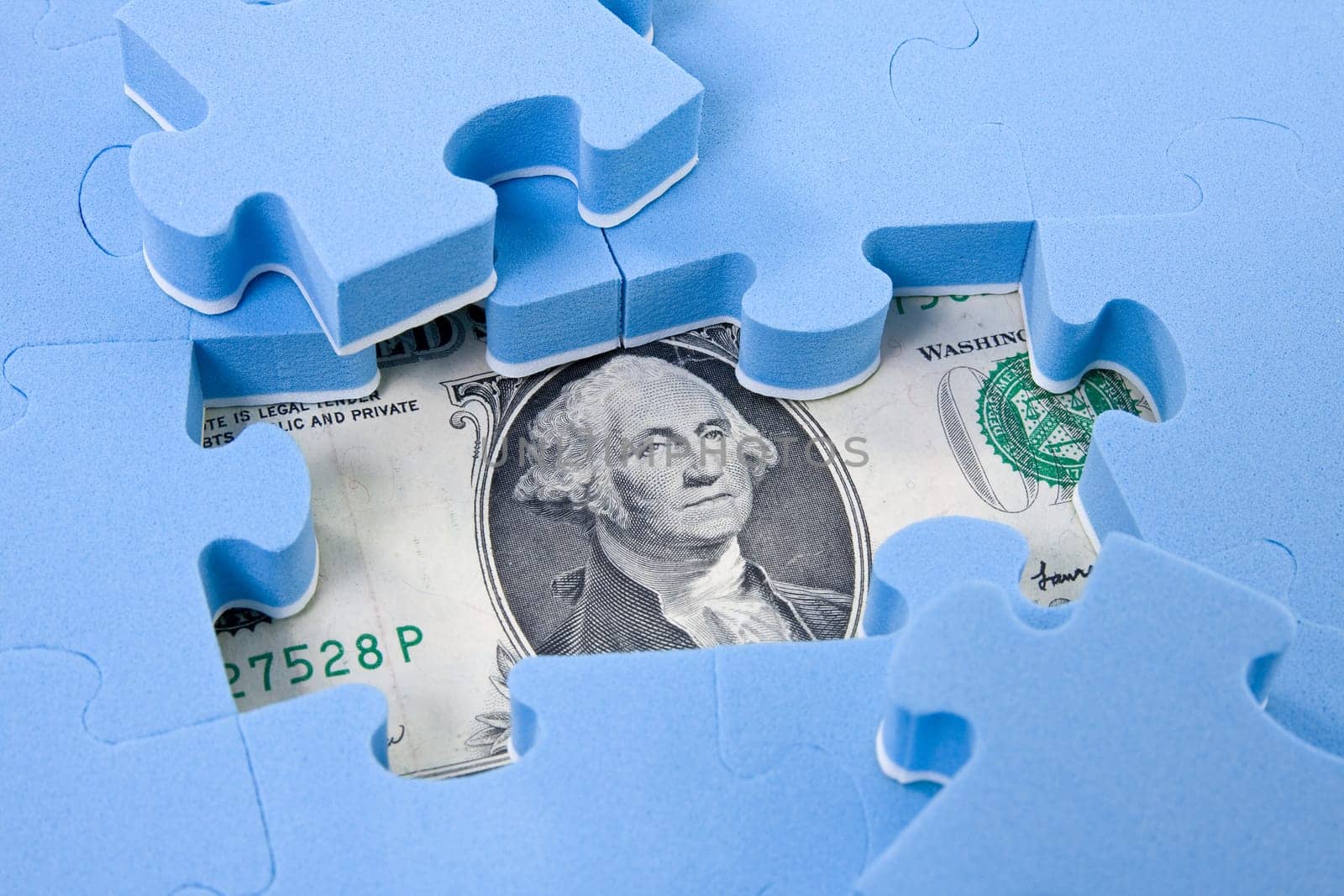 Hidden assets. Puzzle pieces on dollar background