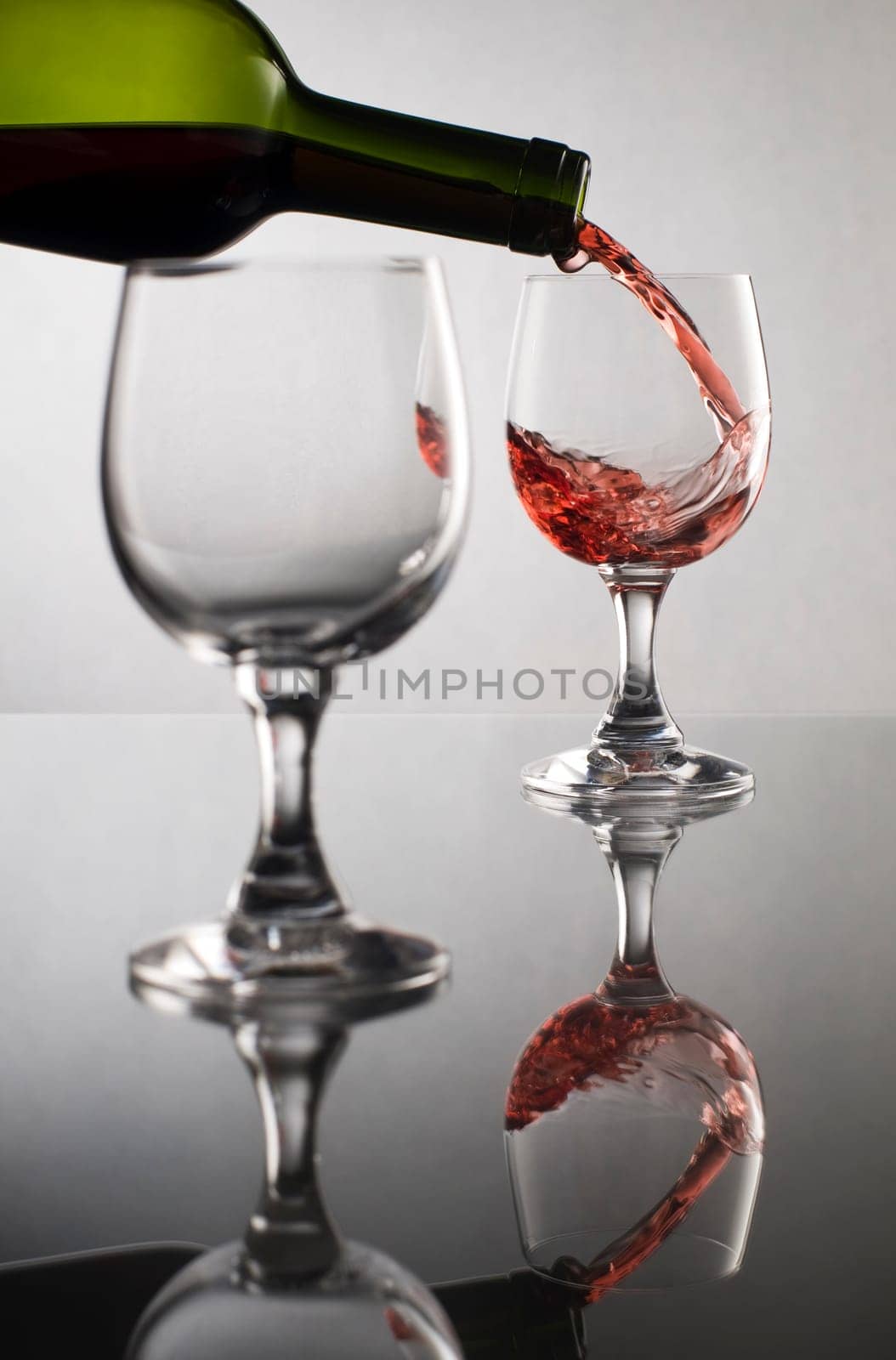 Red wine pouring into glass close up
