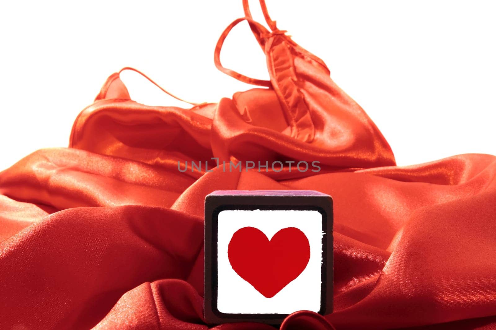 love heart on block on a silk nightie against white background